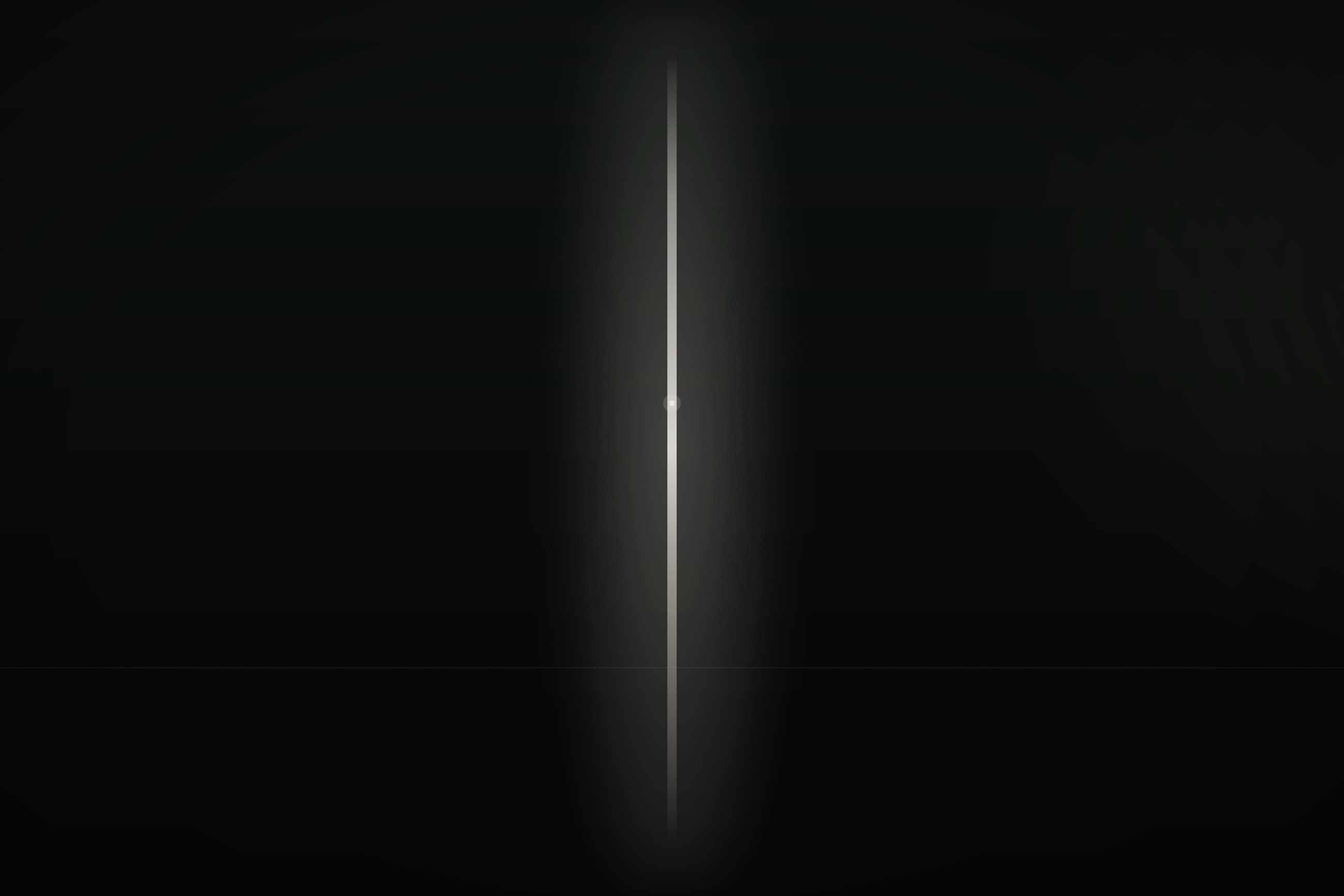 A single column of light held in a dark room